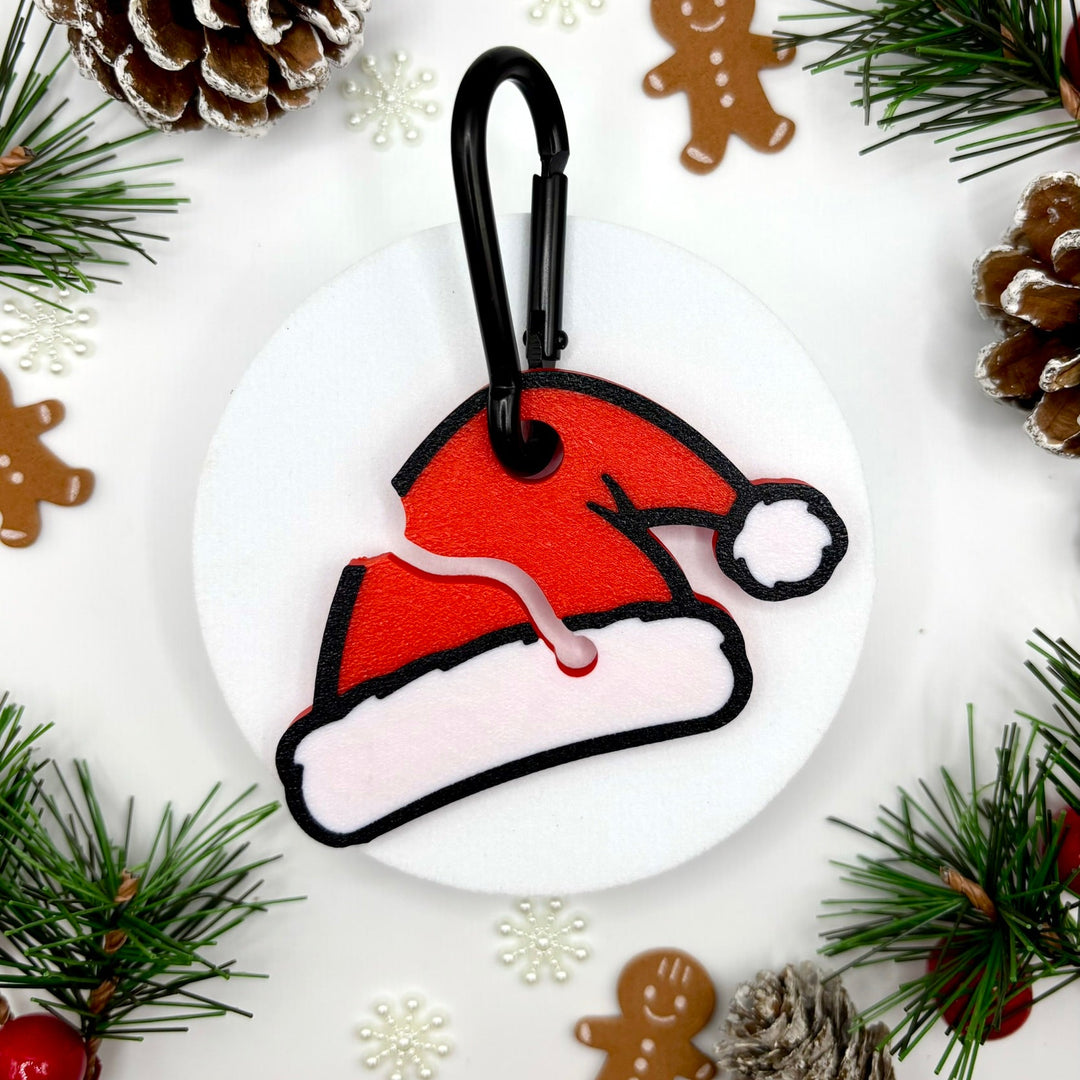 Decorative keychain shaped like a Santa hat with Christmas elements on a white background