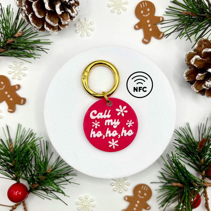 Keychain with red tag surrounded by Christmas decorations